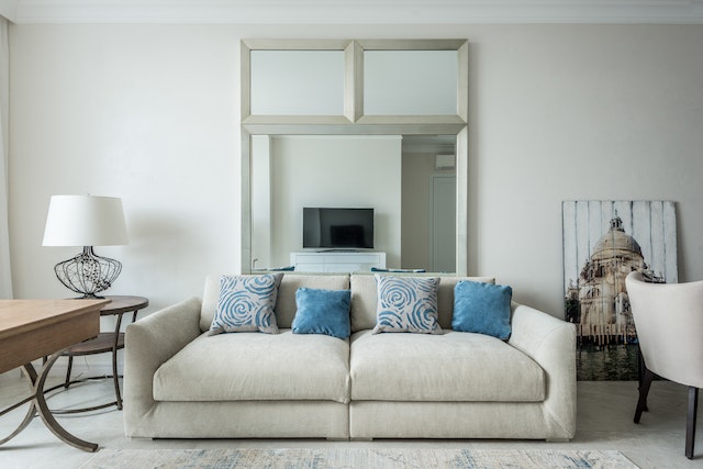 White couch with blue accent pillows