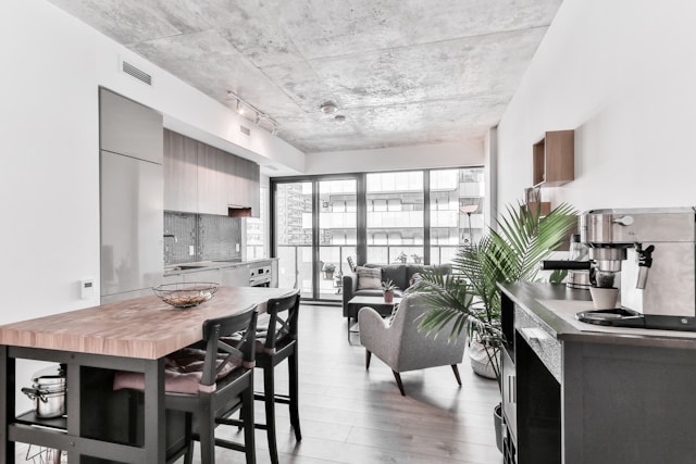 An open-concept kitchen and living room with big windows