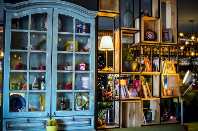 A vintage blue cabinet with colorful details inside