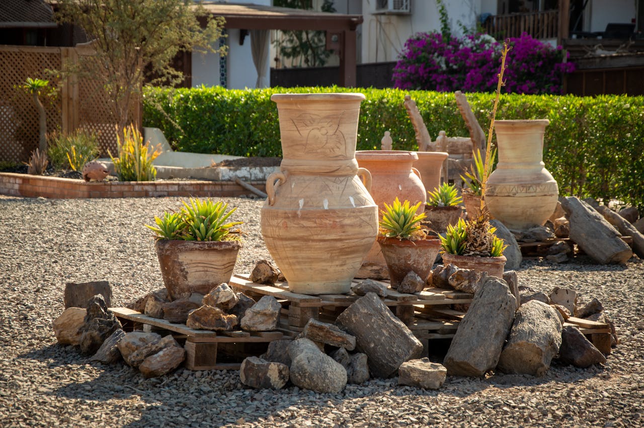 Antique clay vases standing on a patio as an example of pottery in everyday life.