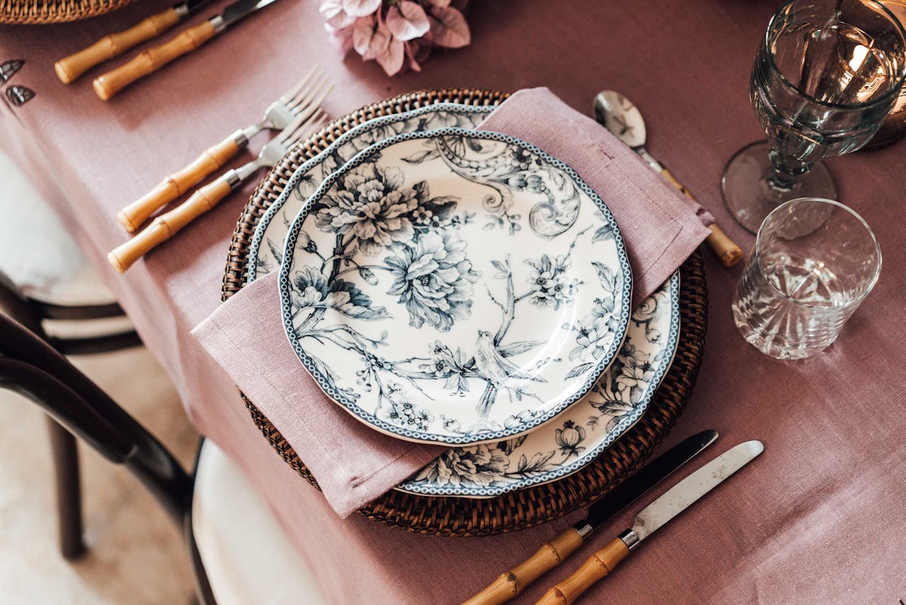 Elegant tableware and cutlery placed near glassware.