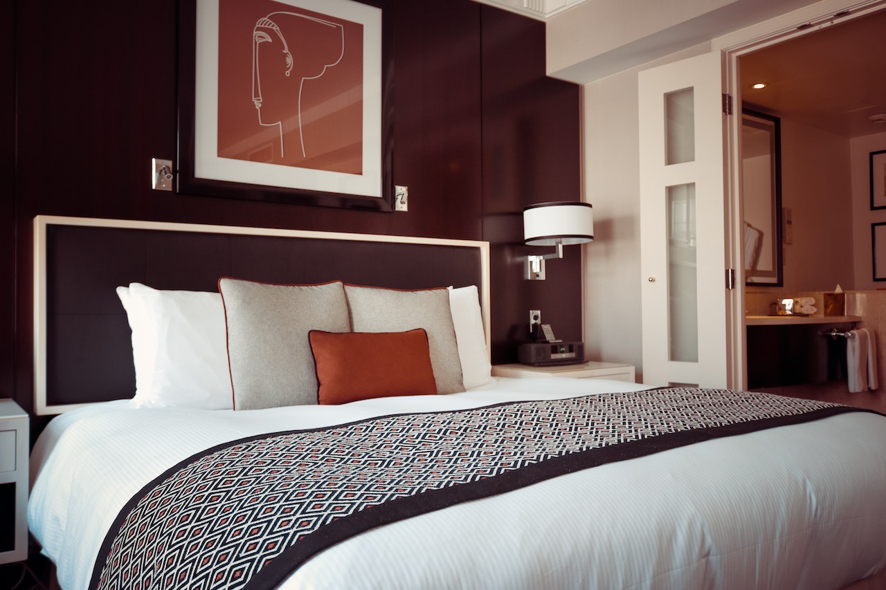 a bedroom decorated with paneling and wall art