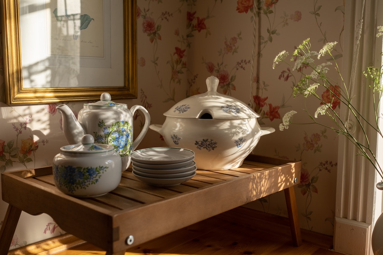 Ceramics in a room with vintage wallpaper.