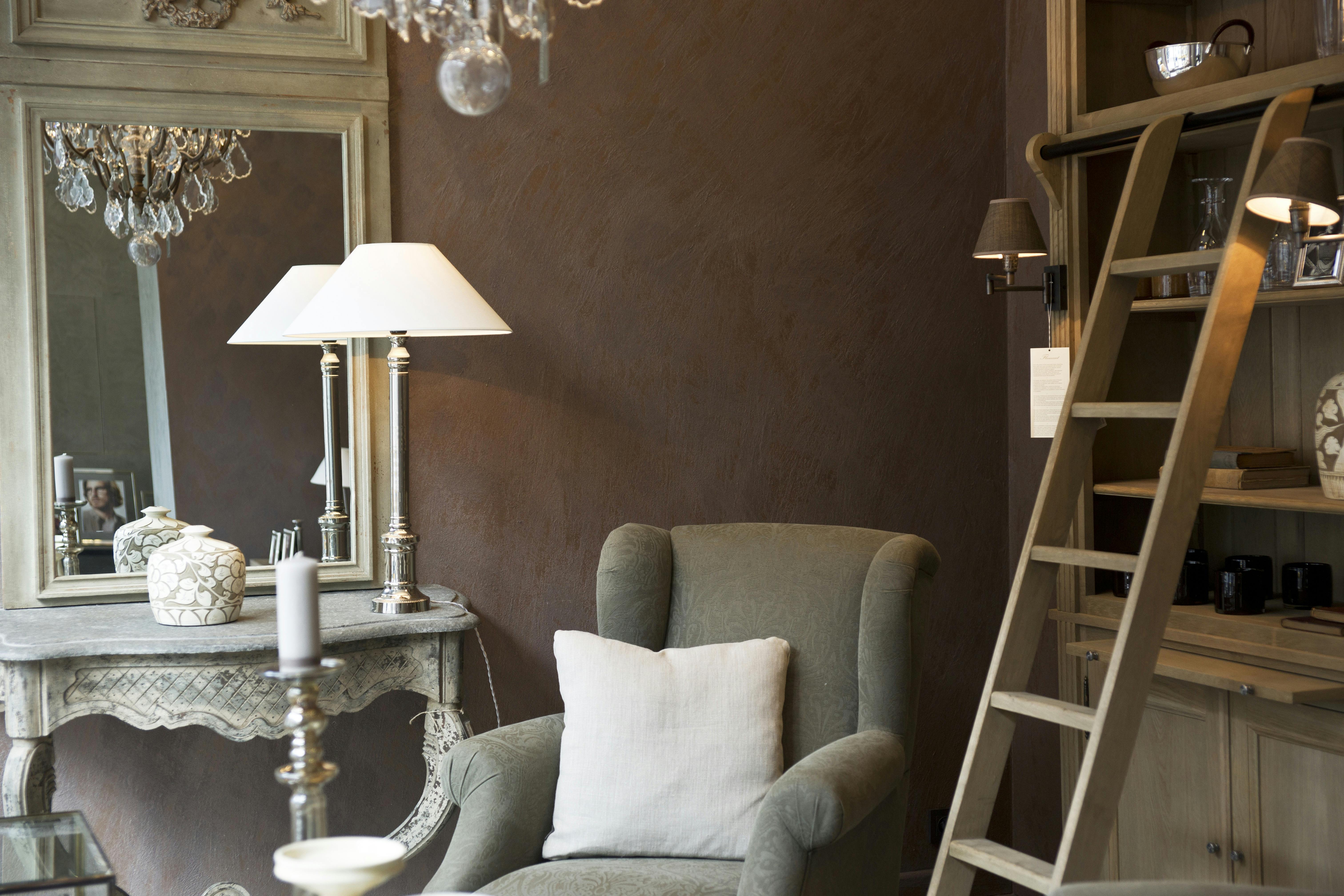 a chair, a mirror, and a lamp, making perfect home décor.