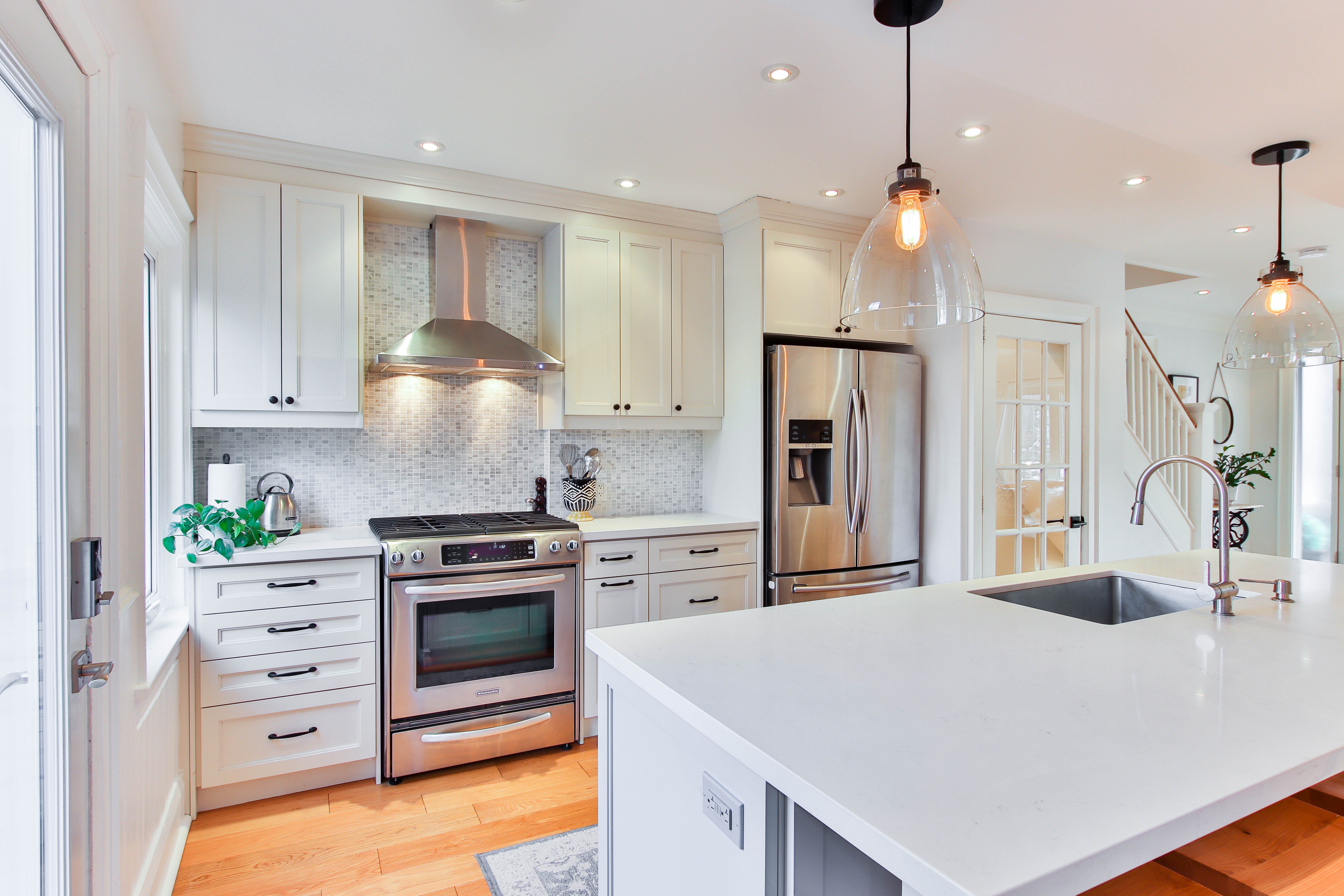 Large and bright kitchen with white countertops and cabinets as an example of how to bring style to your kitchen