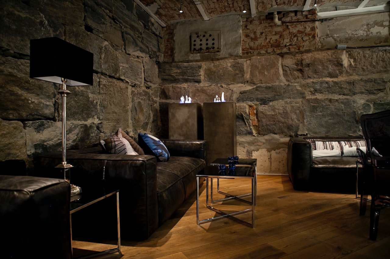 a living room with a stone wall